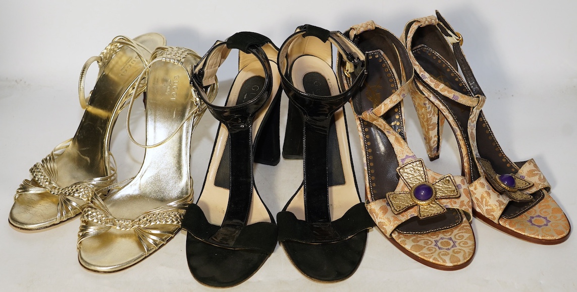 A pair of gold and bamboo Gucci sandals, a pair of Gucci black suede and patient leather sandals and a pair of Yves Saint Laurent gold canvas sandals, sizes 40.5 (Gucci) 40 (YSL)